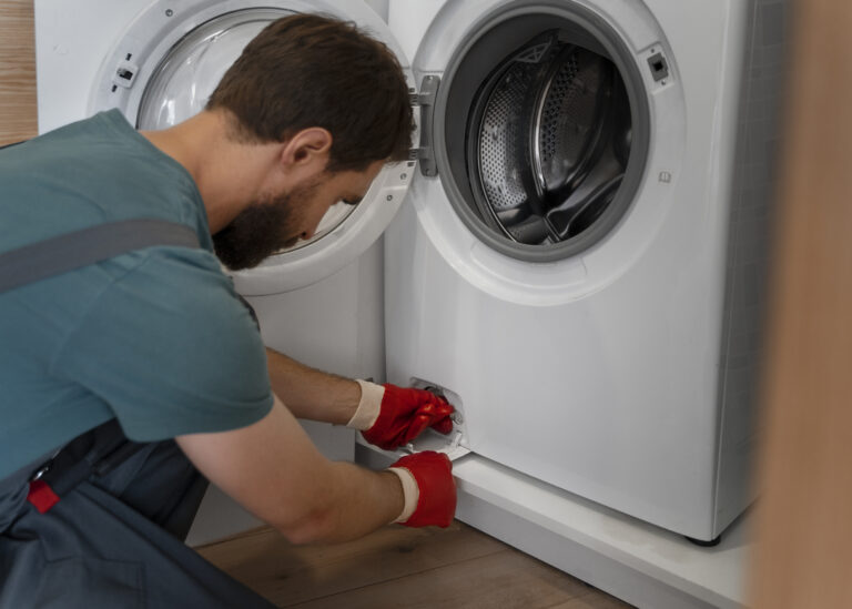 Technician repairing a washing machine during professional washing machine repair in Abu Dhabi